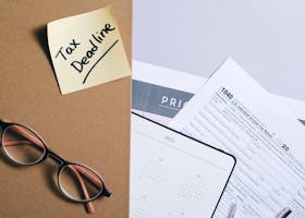 pexels-photo-8962518-8962518 Organized tax preparation essentials with calendar, forms, and deadline reminder.